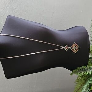 WHBM long gold necklace featuring geometric design